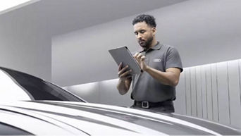 Audi staff member reviewing service plan for A6 Avant performance MY 2023