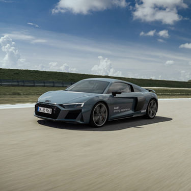 Grey Audi R8 Coupé V10 plus drives on a track