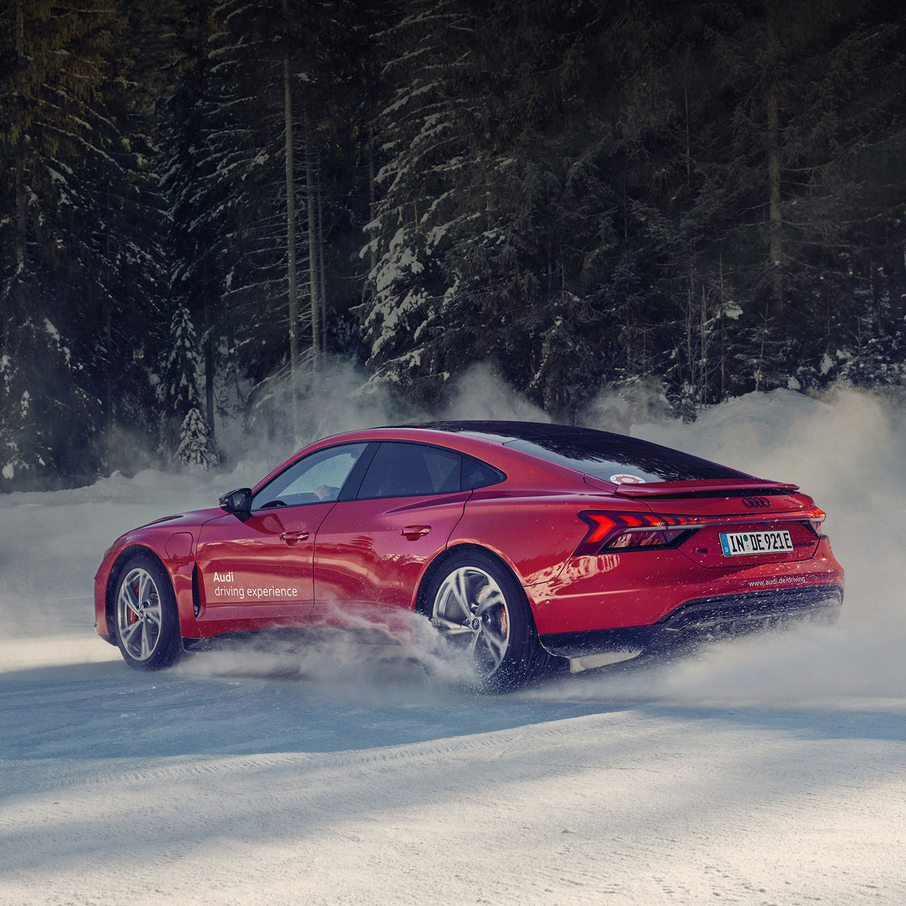 Red Audi RS e-tron GT drifts in the snow 