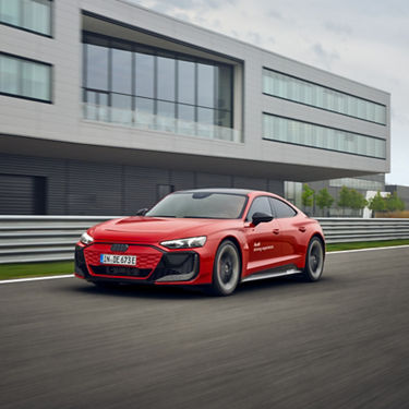 Roter Audi RS e-tron GT performance fährt am Audi driving experience center in Neuburg vorbei