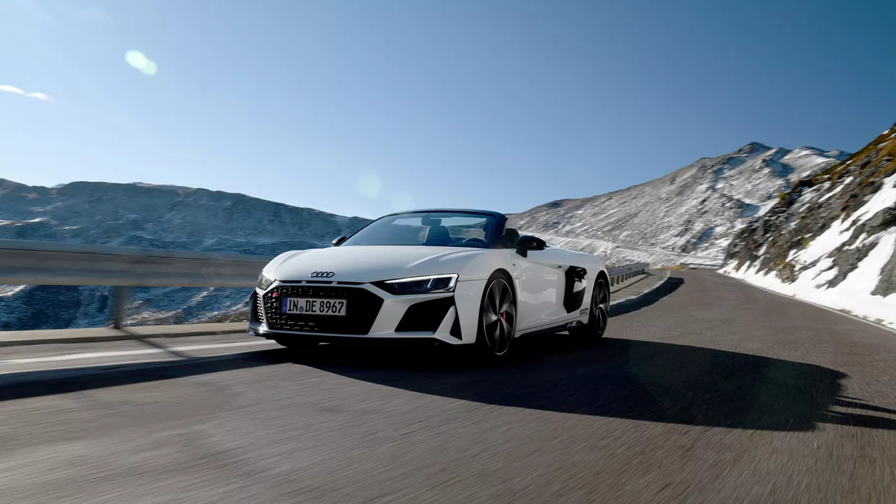 White Audi R8 Spyder drives in the mountains