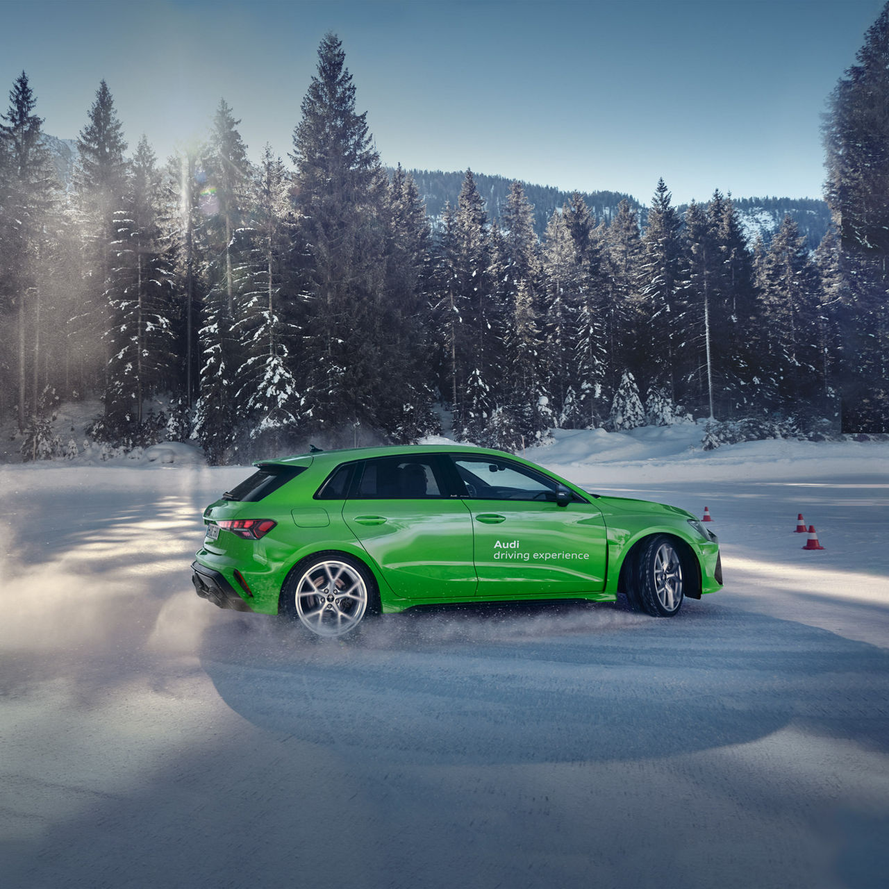 Light green Audi RS 3 Sportback drives in the snow