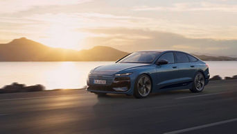 Ein Audi fährt in den Sonnenuntergang