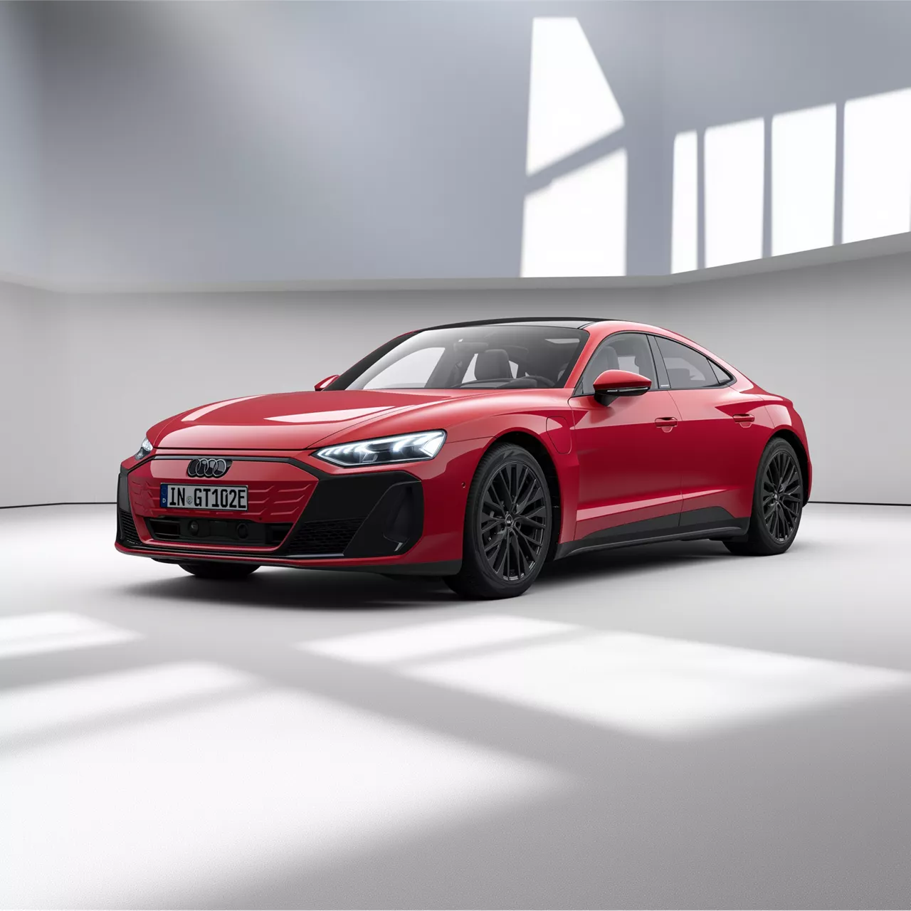 Ein roter e-tron GT quattro fährt auf einer Landstraße entlang einer Küste.