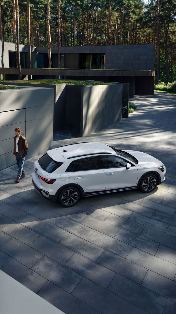 Ein Mann läuft hinter einem weißem Audi