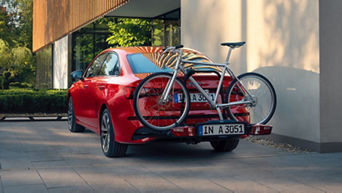 Roter Audi mit Fahrradträger auf der Anhängerkupplung inkl. Fahrrad.