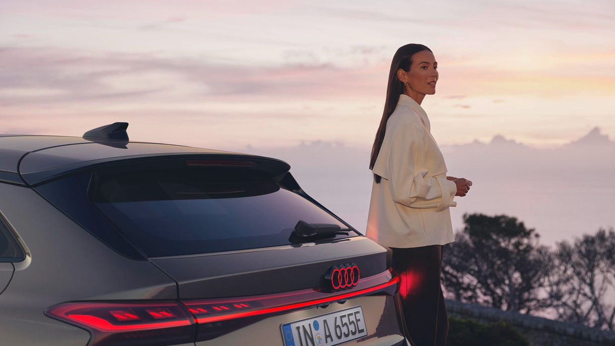 Woman and an Audi A6 Avant e-tron