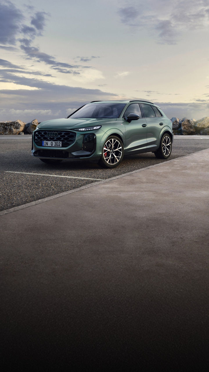 Green Audi Q3 in a car park