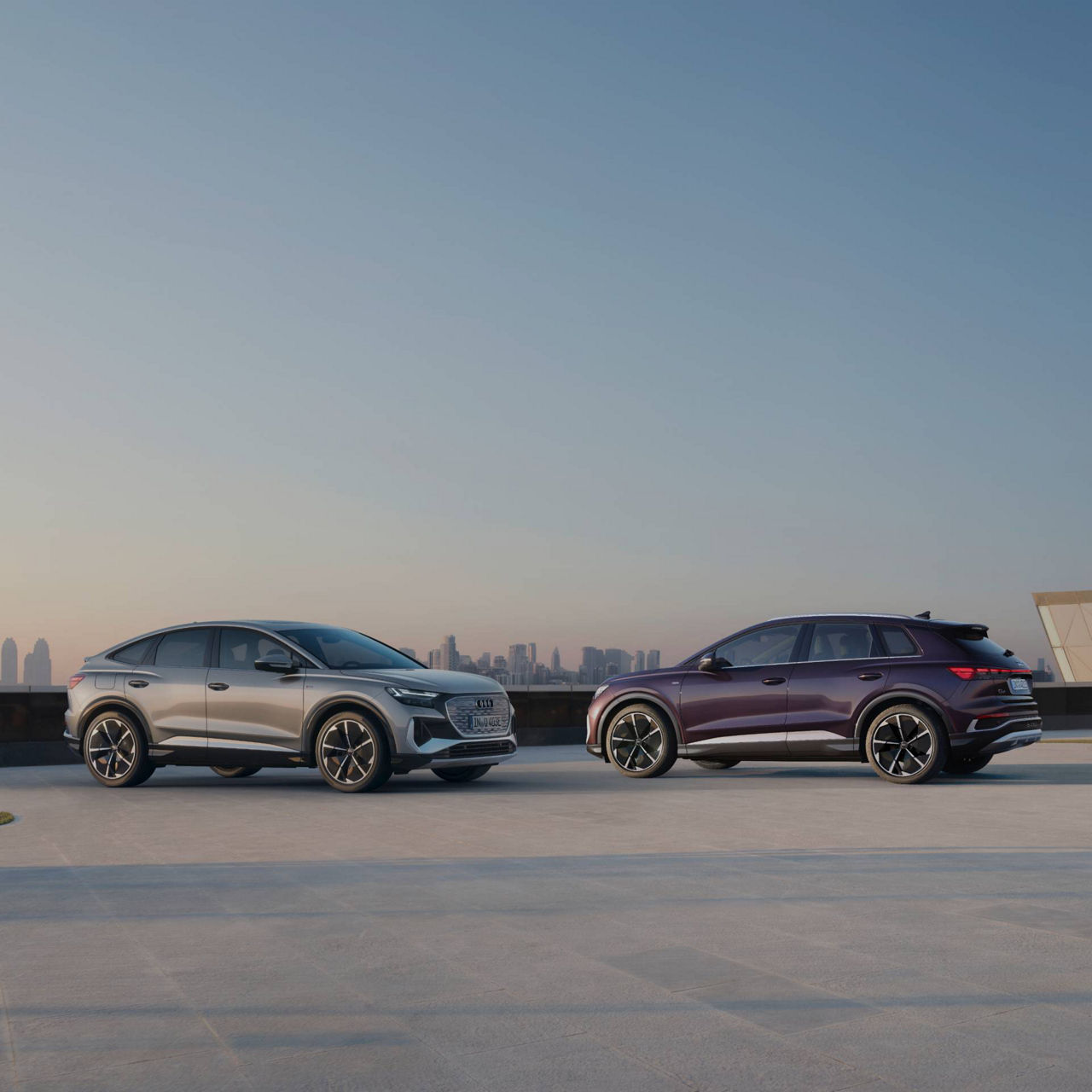 two Audi SUVs in open space