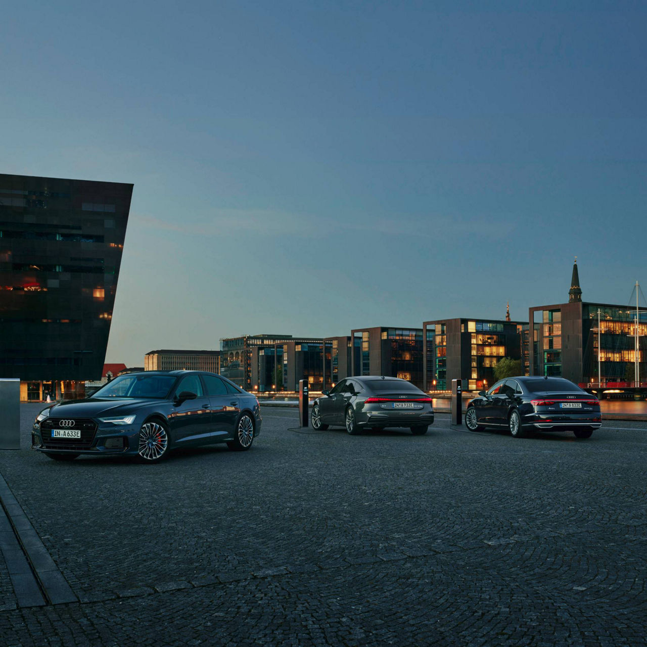 Audi parked up with city building and skyline in the background