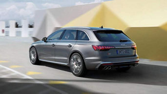 Silver Audi vehicle in motion with an abstract background