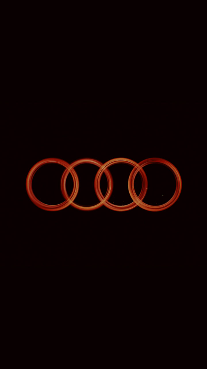 Audi logo rings in fiery red with yellow details on black background