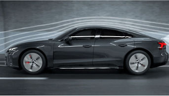 A black Audi vehicle in a wind tunnel with airflow visualisation lines around it 