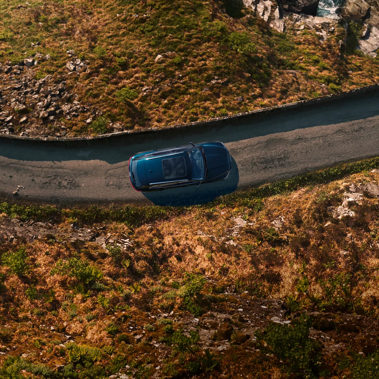 Aerial view of an Audi vehicle driving through a nature landscape