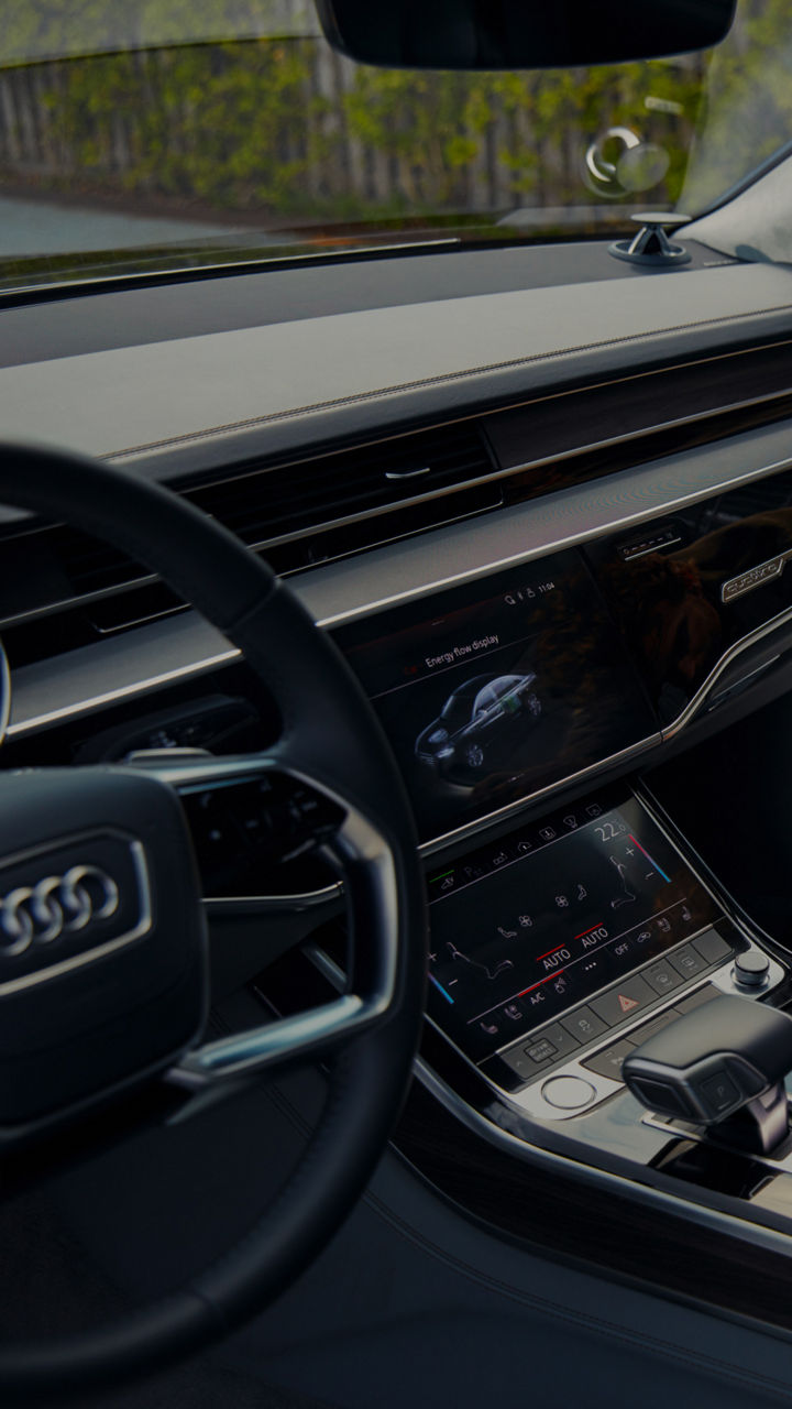 Male hand grabbing a folder inside an Audi vehicle