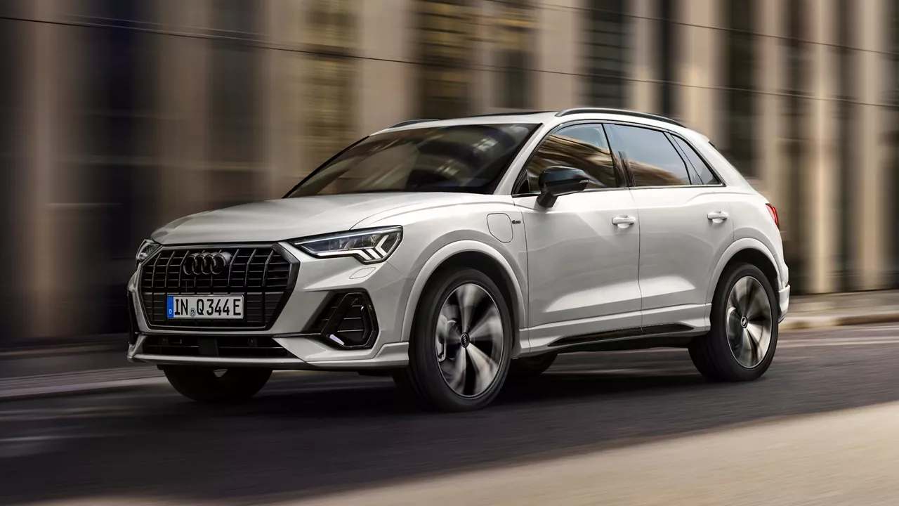 Light grey Audi Q3 on the go, in a city road