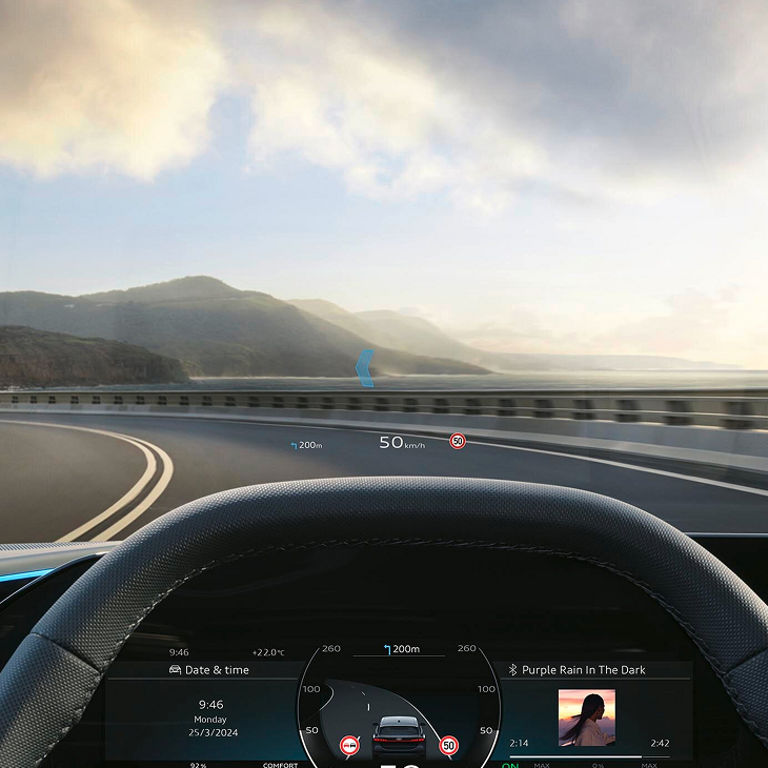 Heads-up display (HUD) on a car windshield showing speed and navigation information.