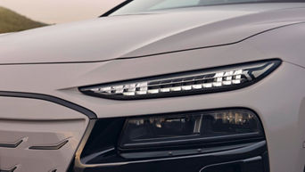Close-up of a car front featuring a modern LED headlight design with signature lighting, showcasing intricate detailing.
