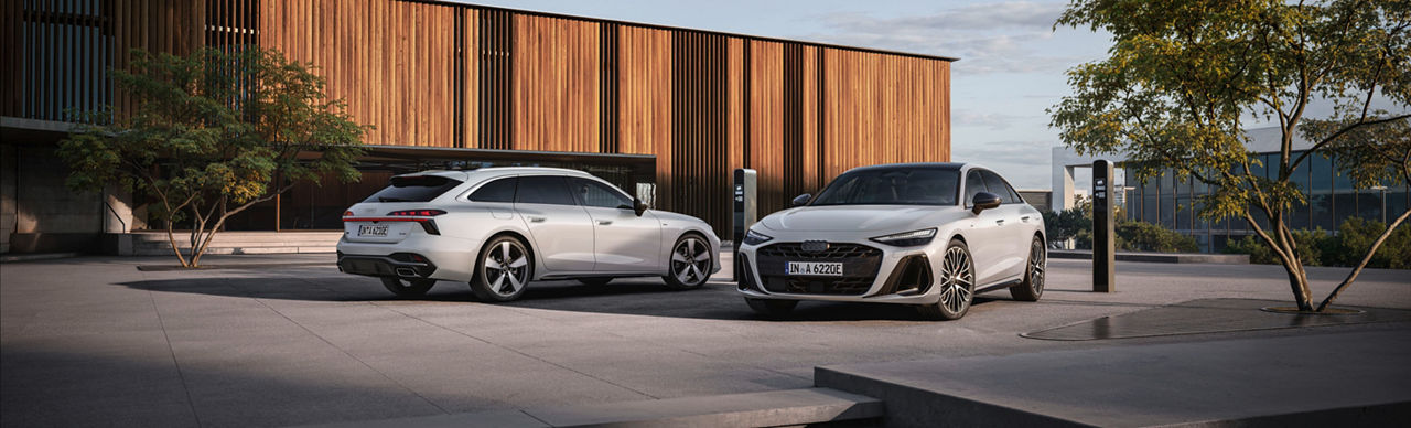 Two white Audi cars side by side facing each other