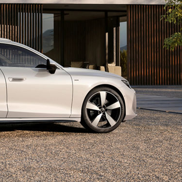 Close up of the right side of An Audi A6 Avant e-hybrid, with focus on the wheel and rims