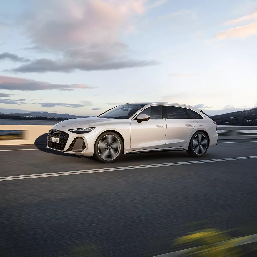 A white Audi A6 Avant e-hybrid on the move