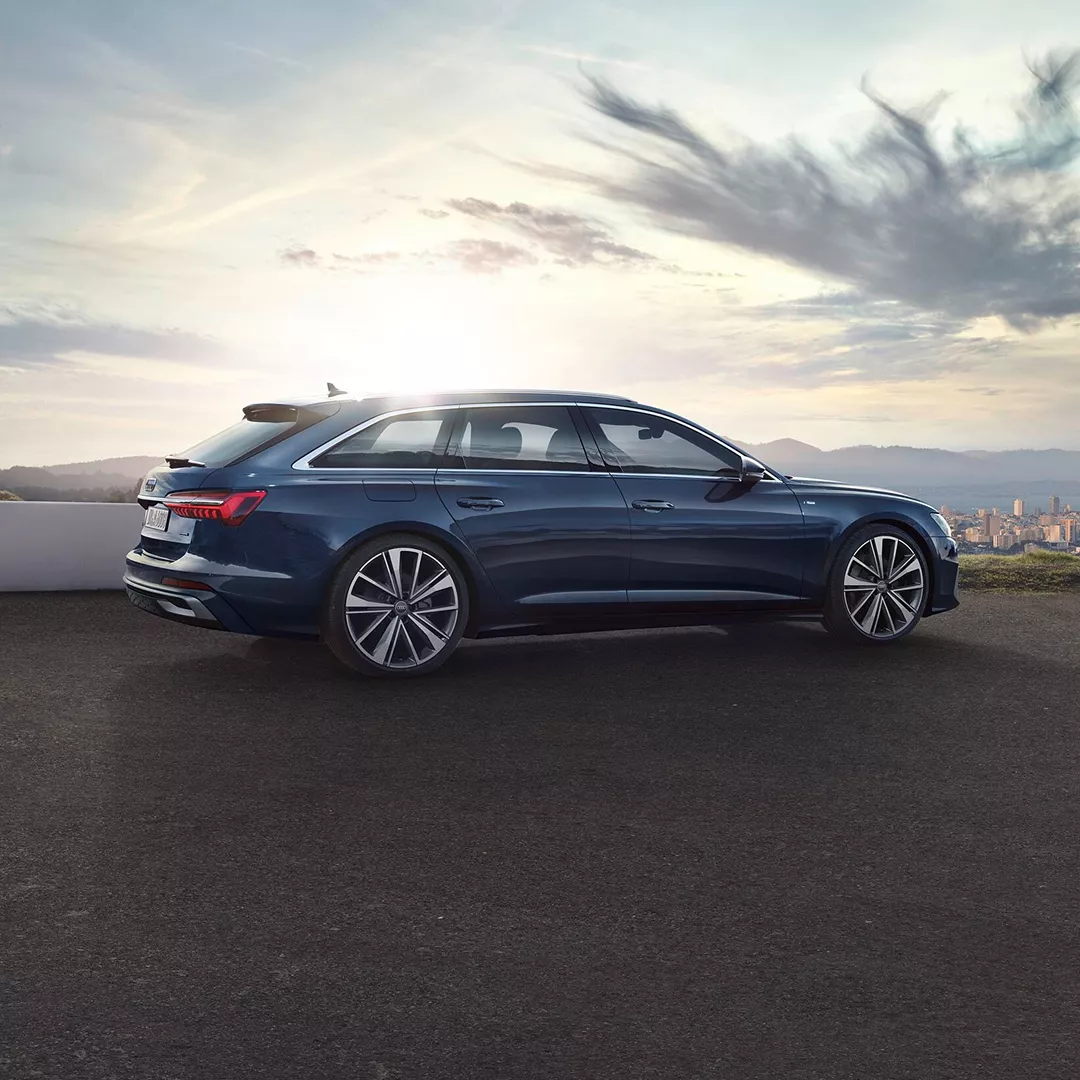 Blue Audi car parked with city view from above at the back