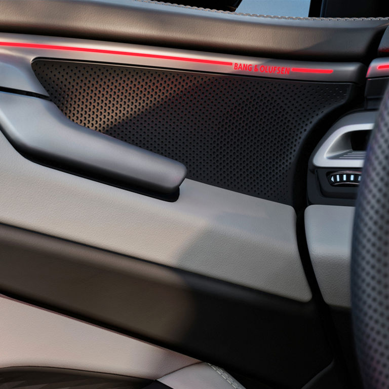 Close up on the interior of an Audi car door with slick design and light elements