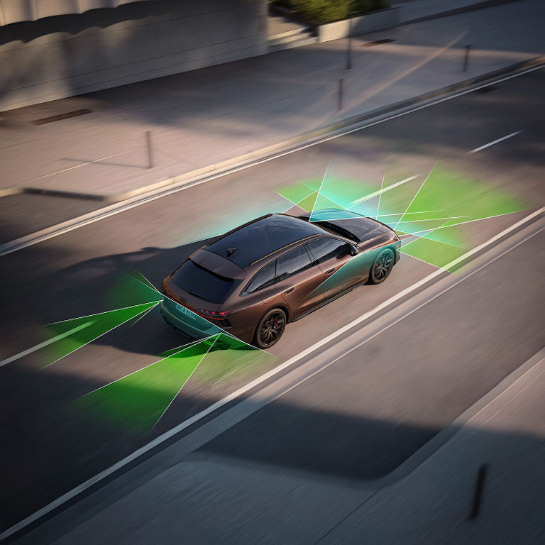 Aerial view of a moving Audi car with active assistance technology features highlighted