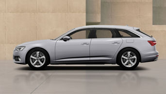 Audi A6 TFSi e parked beside a beige modern building