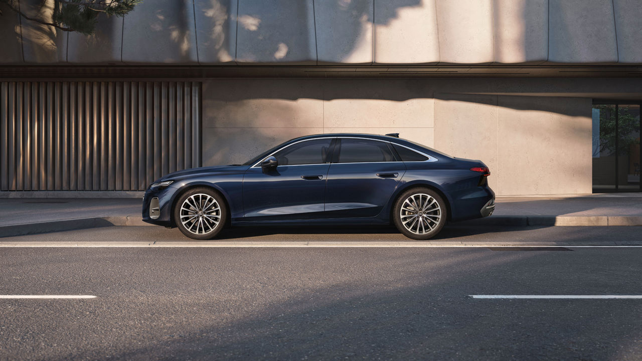 Blue Audi A6 Saloon parked at the side of the road, side view