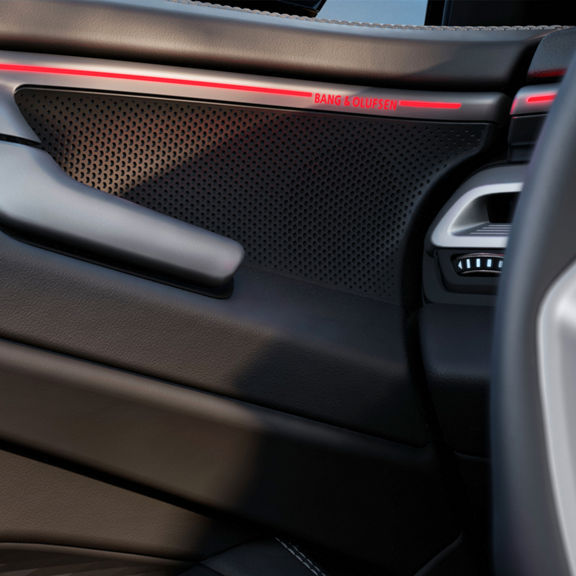 Audi interior car door panel with Bang & Olufsen speaker grille.