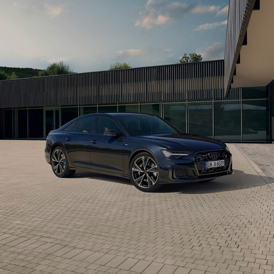 Black Audi A6 Saloon parked in a brick laid road