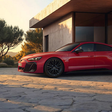Red Audi e-tron GT quattro parked in a modern driveway