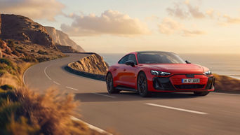 Red Audi e-tron GT quattro on the move in a coastal road