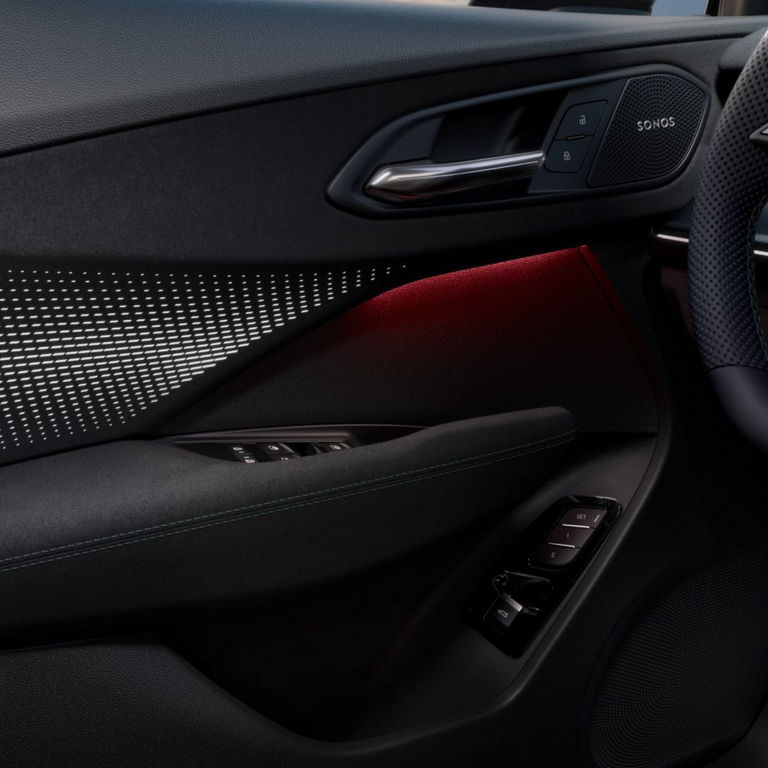 Side door interior of an Audi car with red details