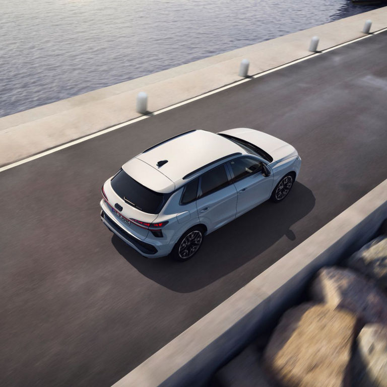 Arial shot of a white Audi Q3 e-hybrid while in motion on the road