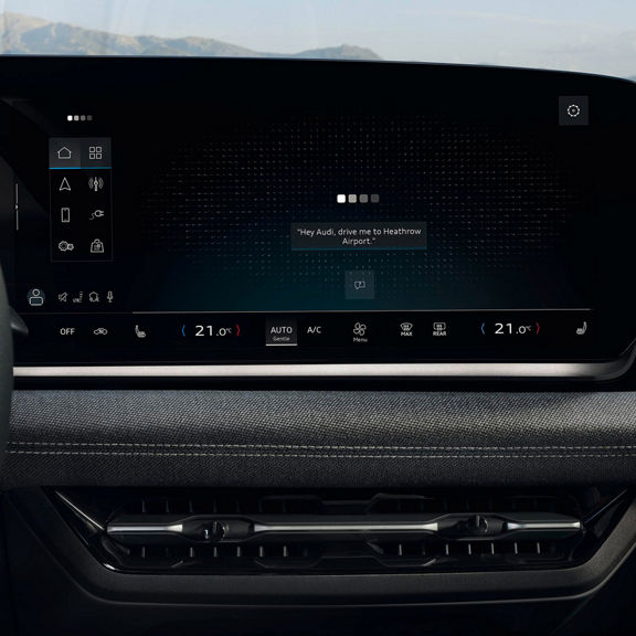Audi Q3 digital touchscreen display showing navigation, climate controls, and a voice command for Heathrow Airport.