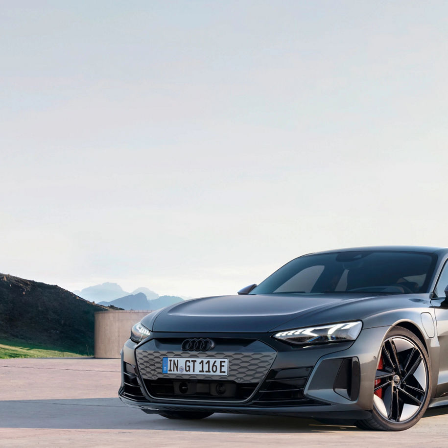 Audi electric car parked outdoors with mountains in the background.