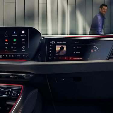 Interior view of an Audi car showcasing steering wheel, dashboard, and infotainment system.