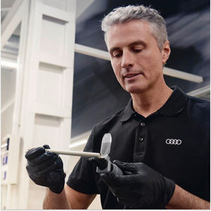 A mechanic pouring oil in a car engine part