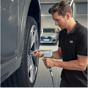 A mechanic checking on the breaks of a car
