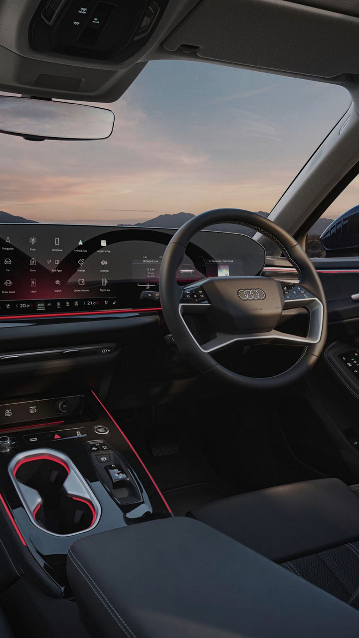 Interior of an Audi vehicle with the front seats, steering wheel and dashboard in view