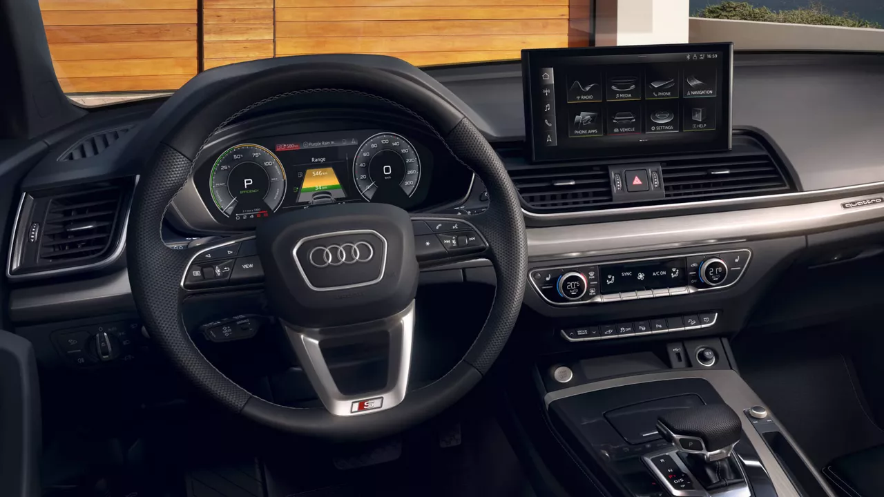 The front interior of an Audi Q5 vehicle with steering wheel and digital dashboard in view