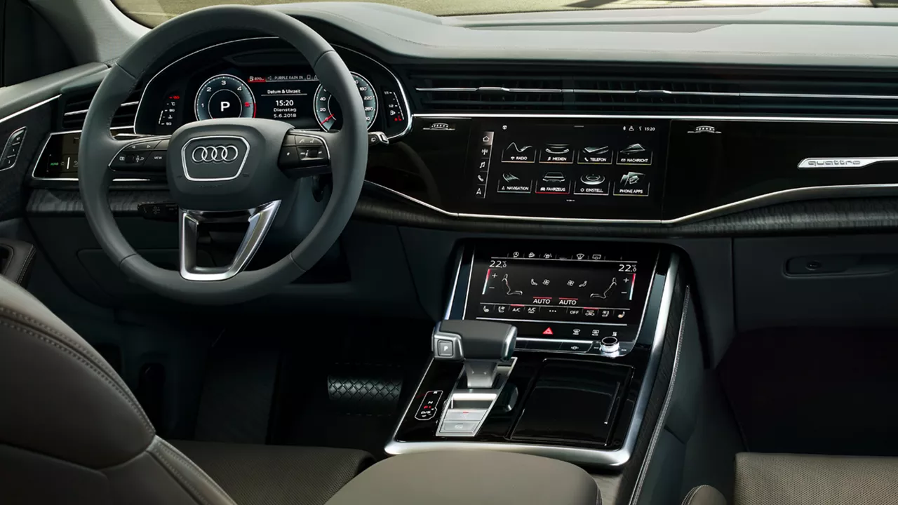 The interior of an Audi Q8 e-tron with the focus on the dashboard and steering wheel 