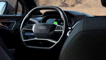 Image of Audi steering wheel taken from behind the passenger seat