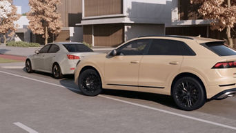 Audi Q6 pulling out from a parking spot into the street