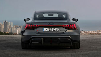 e-tron GT RS back side lights with a view of the ocean in the background