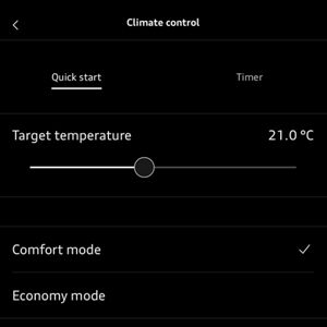 A hand holds a smartphone displaying a climate control app. The screen shows settings like target temperature and economy mode with a green toggle.