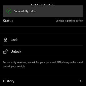 A person holds a smartphone displaying the Audi Q3 Sportback app, showing a low fuel warning and a driving range of 30 miles.
