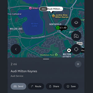 Map showing the location of "Audi Milton Keynes" on Northfield Drive. The interface includes options for sending, routing, and saving the address.